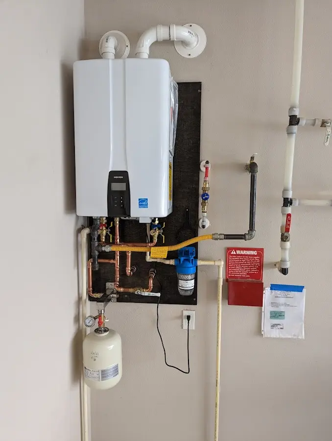 Professional plumber installing copper piping in a McHenry home